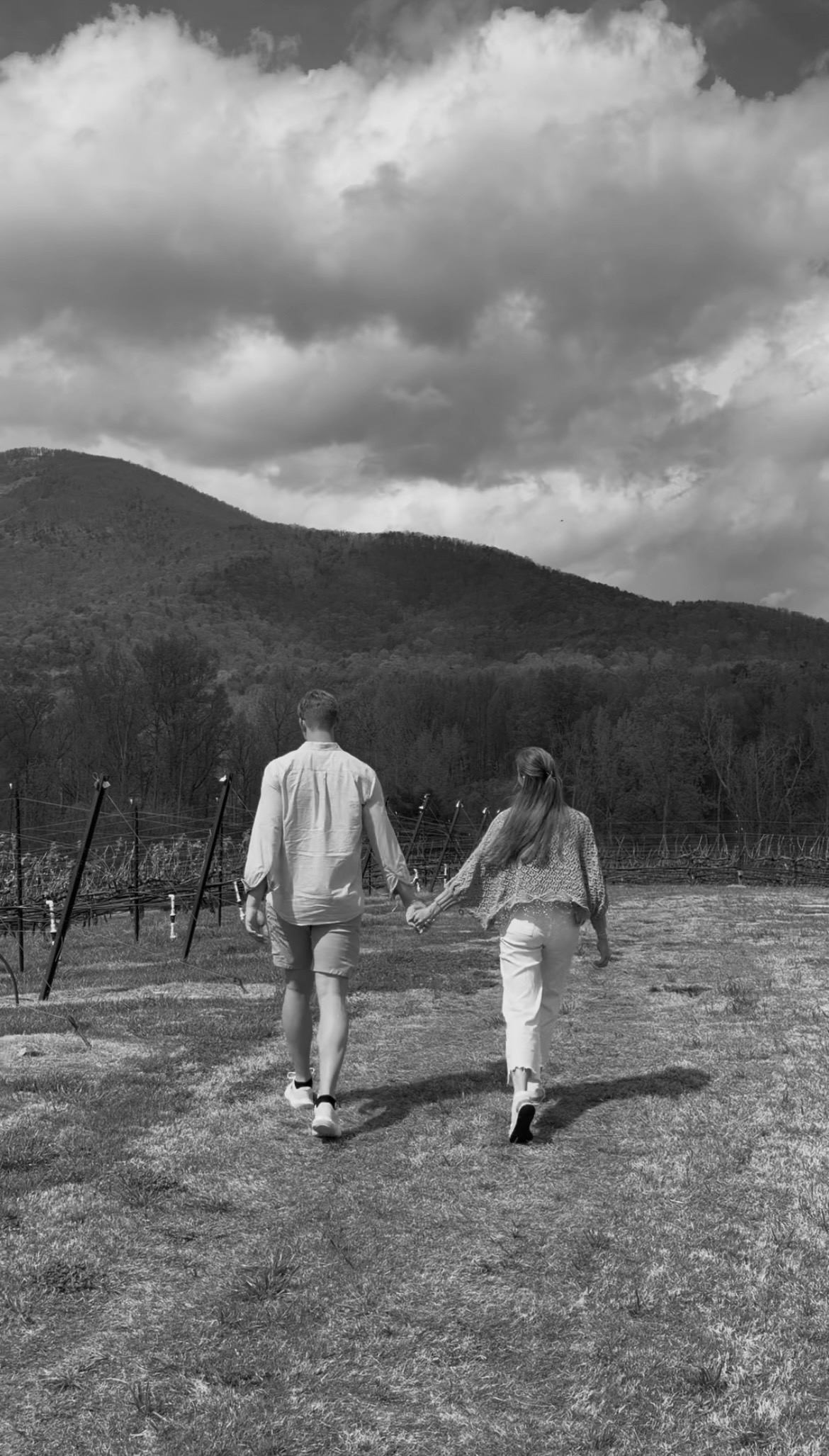 Alanna Wolfe and Boone Bramwell celebrating with their rings in front of a future Mr. and Mrs. sign